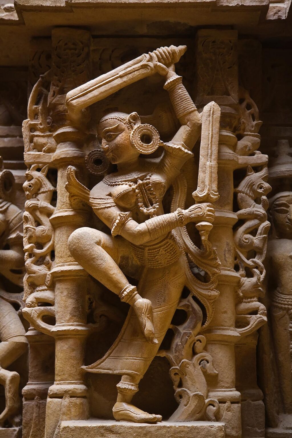 HAND CARVED SANDSTONE DIVA with SWORDS in an ancient JAIN TEMPLE inside JAISALMER FORT - RAJASTHAN, INDIA
