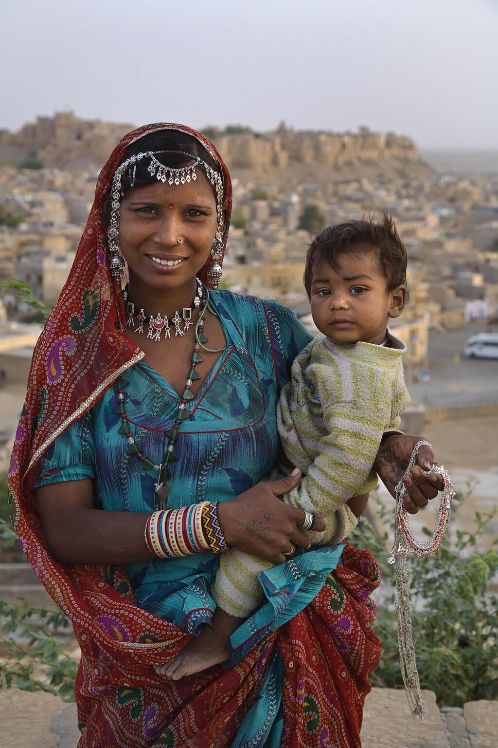 A BANJARI TRIBAL WOMAN and her son with traditional silver jewelry in the GOLDEN CITY of JAISALMER - RAJASTHAN, INDIA