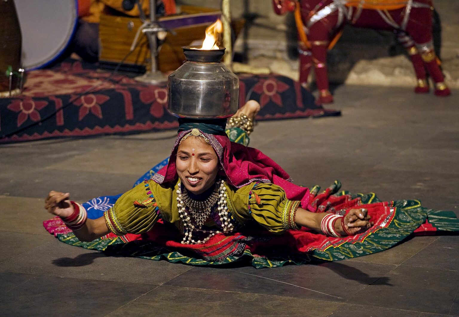 A Rajasthani woman performs a traditional DANCE with a flaming pot on her head at the BAGORE KI HAVELI in UDAIPUR - RAJASTHAN, INDIA