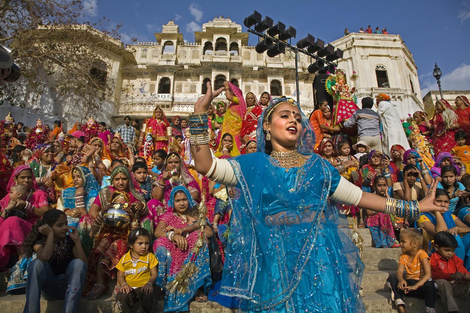 A Rajasthani girl dressed in her finest dances at the GANGUR FESTIVAL also known as the MEWAR FESTIVAL - UDAIPUR, RAJASTHAN, INDIA