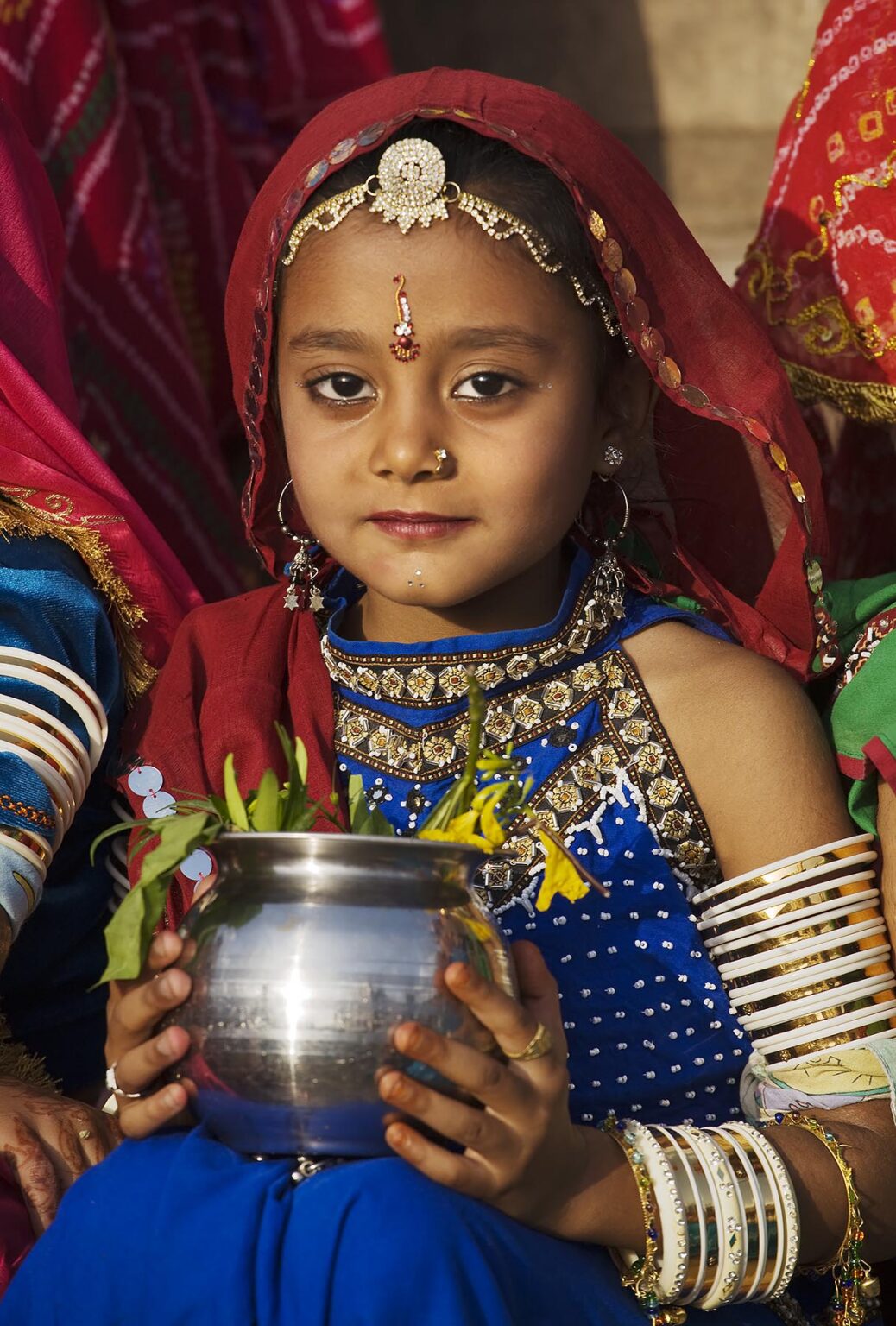 A Rajasthani girl dressed in her finest clothing and jewelry to celebrate the GANGUR FESTIVAL also know as the MEWAR FESTIVAL - UDAIPUR, RAJASTHAN, INDIA