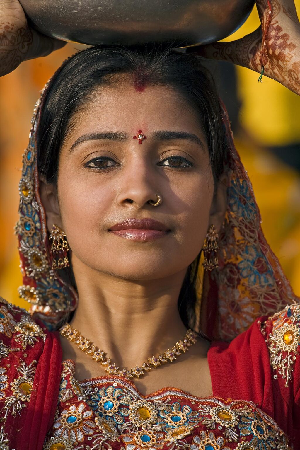 A Rajasthani woman dresses in her finest clothing and jewelry to celebrate at the GANGUR FESTIVAL or MEWAR FESTIVAL in UDAIPUR, RAJASTHAN, INDIA
