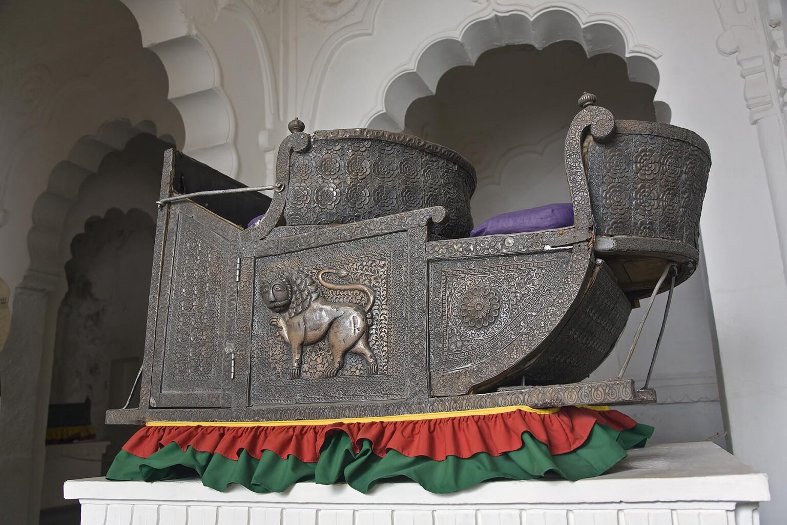 An elaborately sculpted HOWDAH with a lion motif for riding elephants in the MEHERANGARH FORT museum - JOHDPUR, RAJASTHAN, INDIA