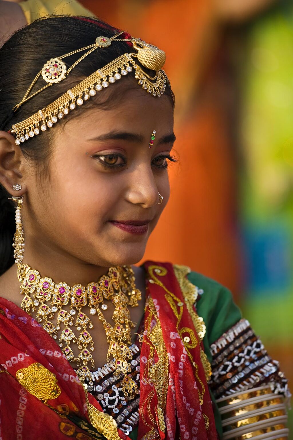 A Rajasthani girl dressed in her finest clothing and jewelry to celebrate the GANGUR FESTIVAL also know as the MEWAR FESTIVAL - UDAIPUR, RAJASTHAN, INDIA