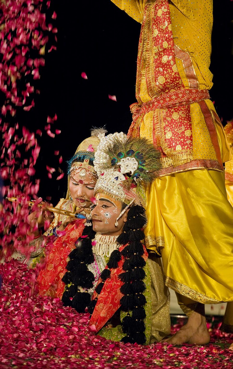 KRISHNA and RHADA are covered in rose petals during a play at the GANGUR FESTIVAL or MEWAR FESTIVAL - UDAIPUR, RAJASTHAN, INDIA