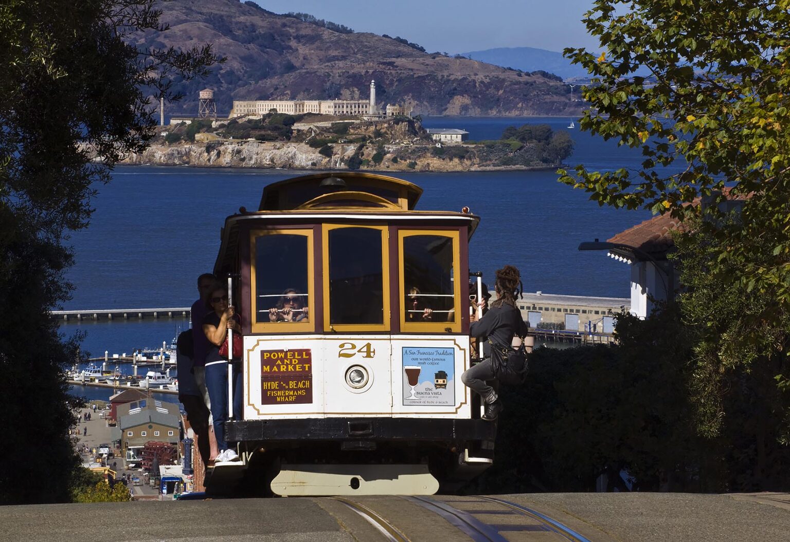 A POWELL and MARKET CABLE CAR with a view of ALCATRAZ ISLAND - SAN FRANCISCO, CALIFORNIA
