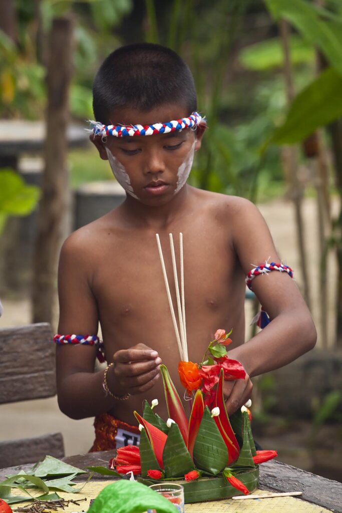 A Thai boy makes a Loi Krathong float during the festival at the HOME AND LIFE ORPHANAGE in PHANGNGA - KHAO LOK, THAILAND