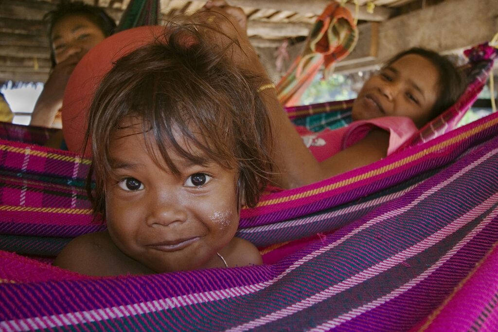 Moken (sea gypsy) child swings in a hammock in his village on Ko Surin Thai Island in Mu Ko Surin National Park - ANDAMAN SEA,THAILAND