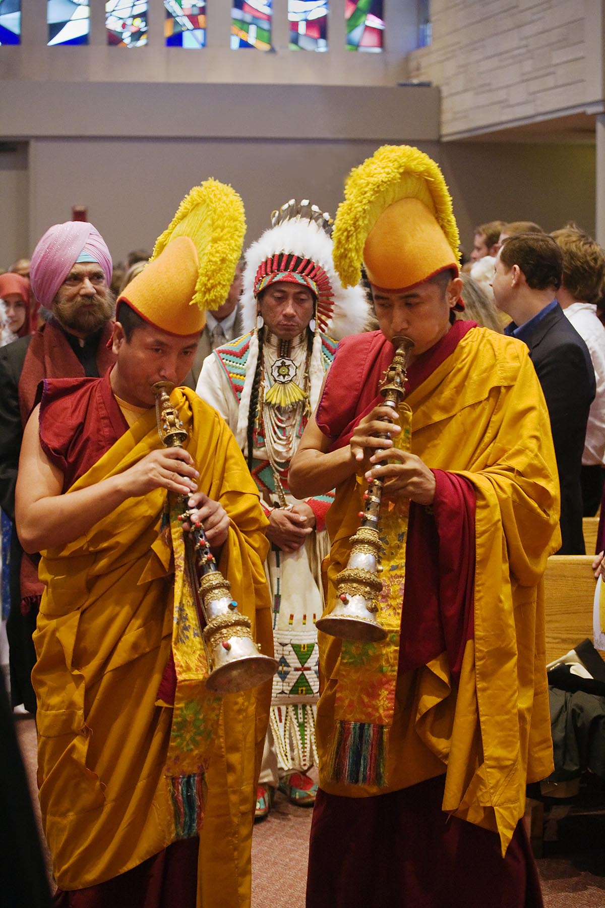 A SIKH K.P. SING, SHOSHONE tribesman JAMES TROSPER and TIBETAN BUDDHIST MONKS blowing horns attend the INTERFAITH PRAYER SERVICE with the DALAI LAMA - ST PAUL CATHOLIC CENTER, BLOOMINGTON, INDIANA