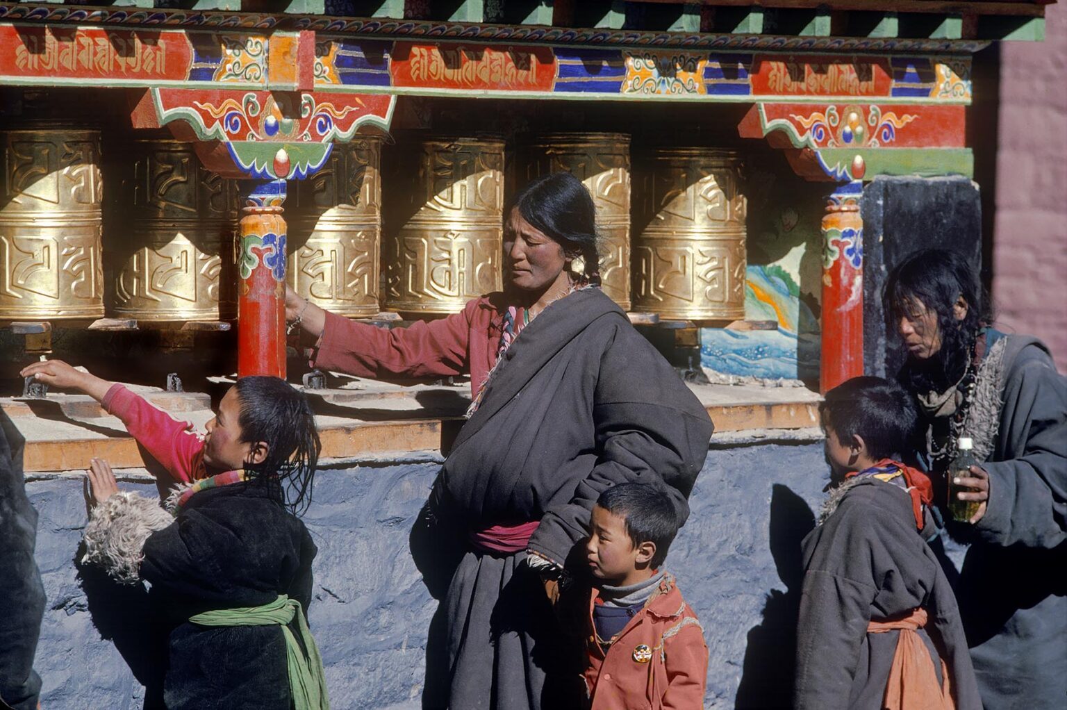 Pilgrims spin prayer wheels at Sakya Monastery - Sakya, Tibet