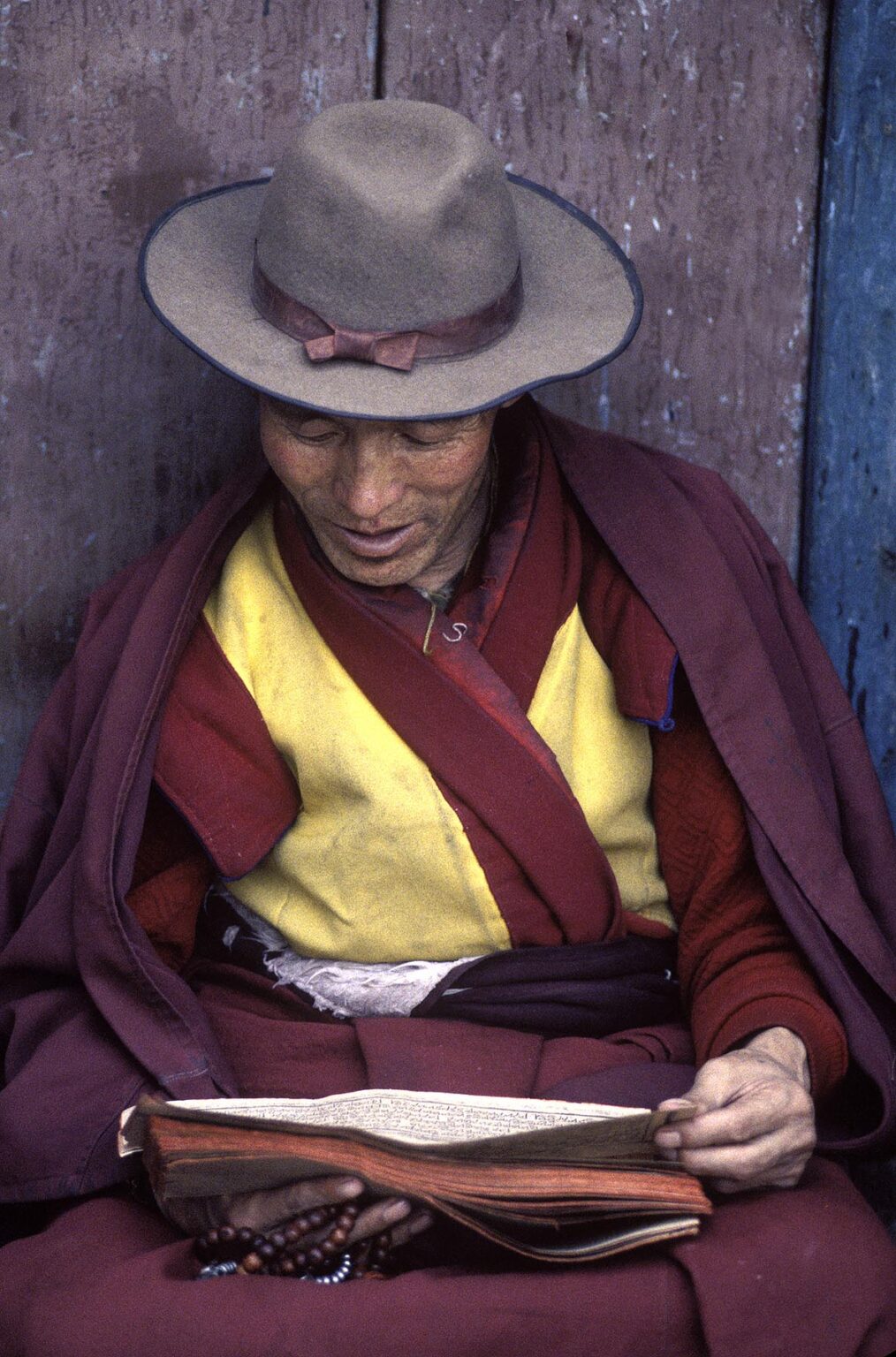 A TIBETAN BUDDHIST MONK reads the SCRIPTURES on the BARKHOR (Tibetan Bazaar) - LHASA, TIBE