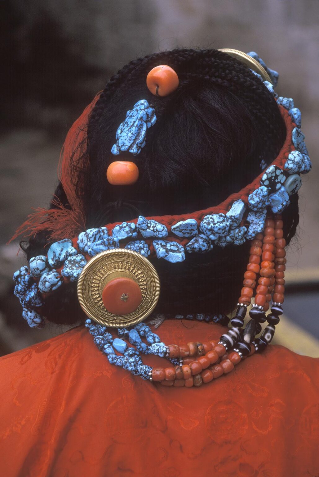 TURQUOISE, CORAL and GOLD decorate this TIBETAN WOMAN'S hair - LHASA, TIBET