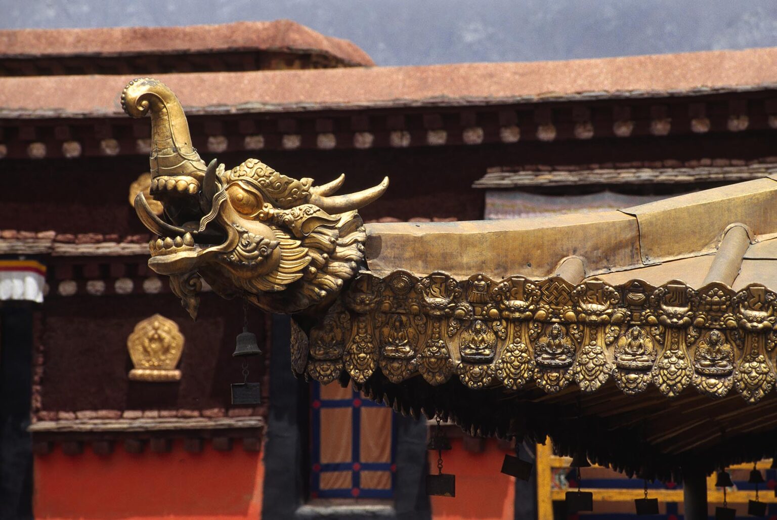 A GOLDEN DRAGON is one of the many elaborate ROOF DETAILS found on the JOKHANG - LHASA, TIBET