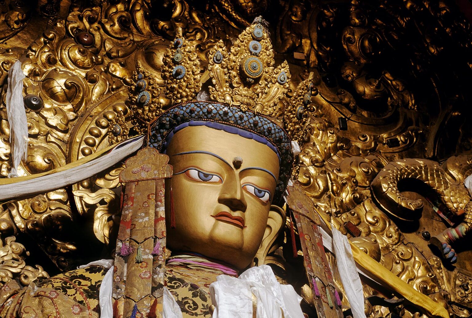Beautiful JEWEL ENCRUSTED STATUE OF MAITREYA (future Buddha) in the MAIN ASSEMBLY HALL at DREPUNG MONASTERY