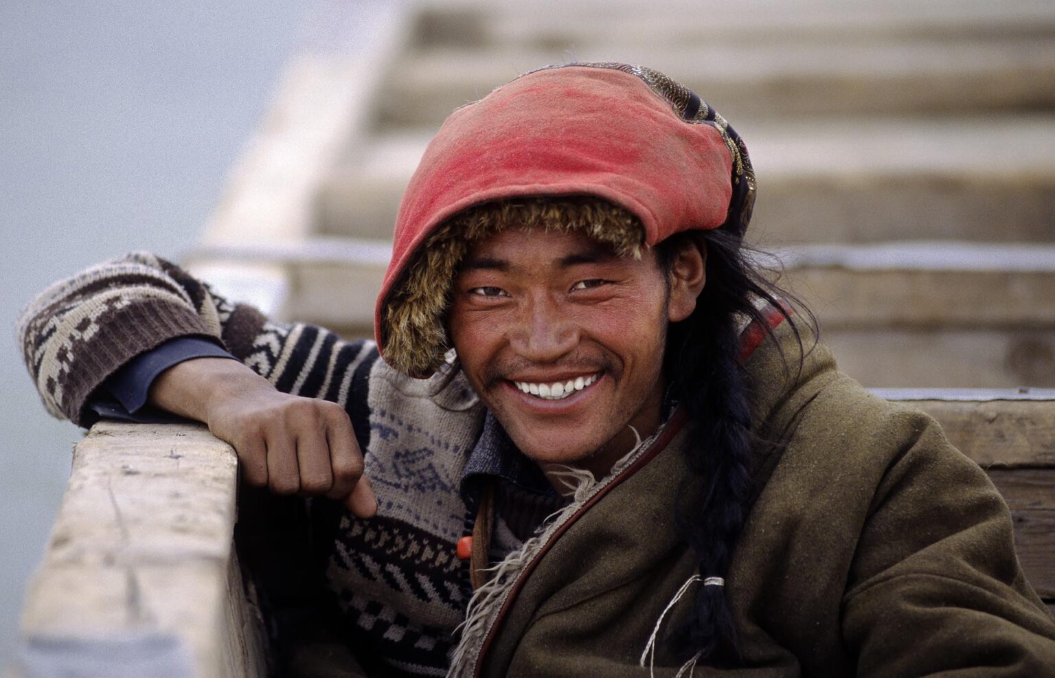 Handsome AMDO MAN sits in a boat as we cross the BRAMAHAPUTRA RIVER also know as the YARLUNG TSAMPO to SAMYE MONASTERY - TIBET