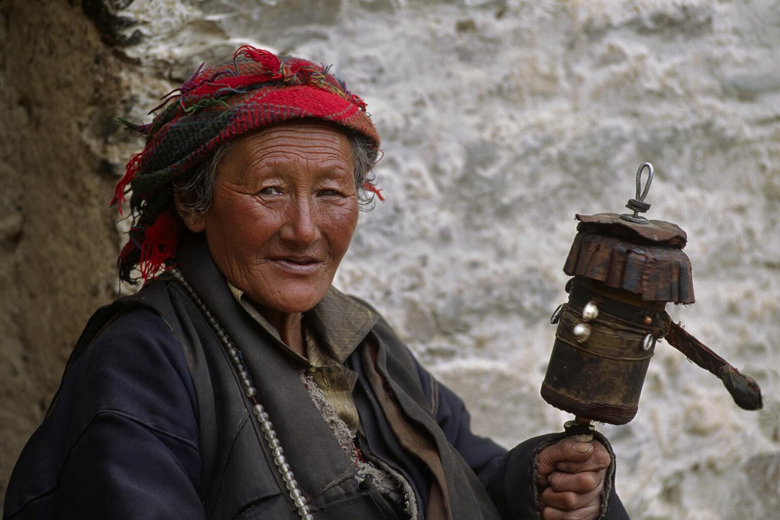 PILGRIM with PRAYER WHEEL at TERDROM NUNNERY started by YESHE TSOGYEL in the 770's AD - TIBET