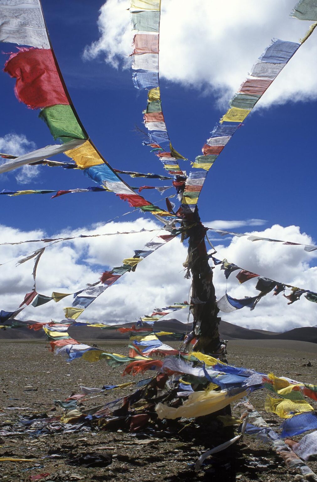 PRAYER FLAGS fly atop the LALUNG LA (PASS) at over 17,000 feet in elevation along the FRIENDSHIP HIGHWAY - TIBET