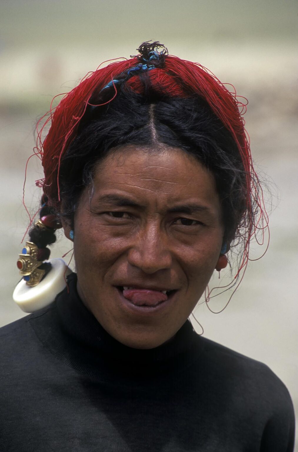 A male DROKPA (Tibetan nomadic yak herder) from KHAM wheres red tassles in his hair - SOUTH WESTERN, TIBET