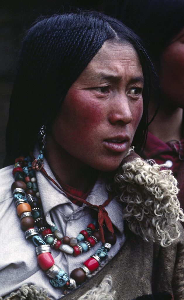 Tibetan pilgrim woman with beautiful jewelry & traditional 108 braids at Sera Monastery - Lhasa, Tibet