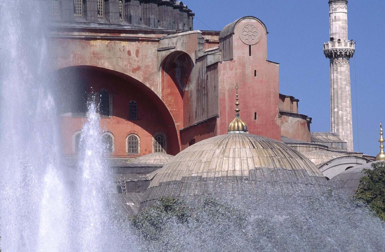 Water fountain and The Ayasofya Camii (St Sophia Cathedral) - Byzantine church originally built in 537 AD, & eventually converted to a Mosque - Istanbul. Turkey