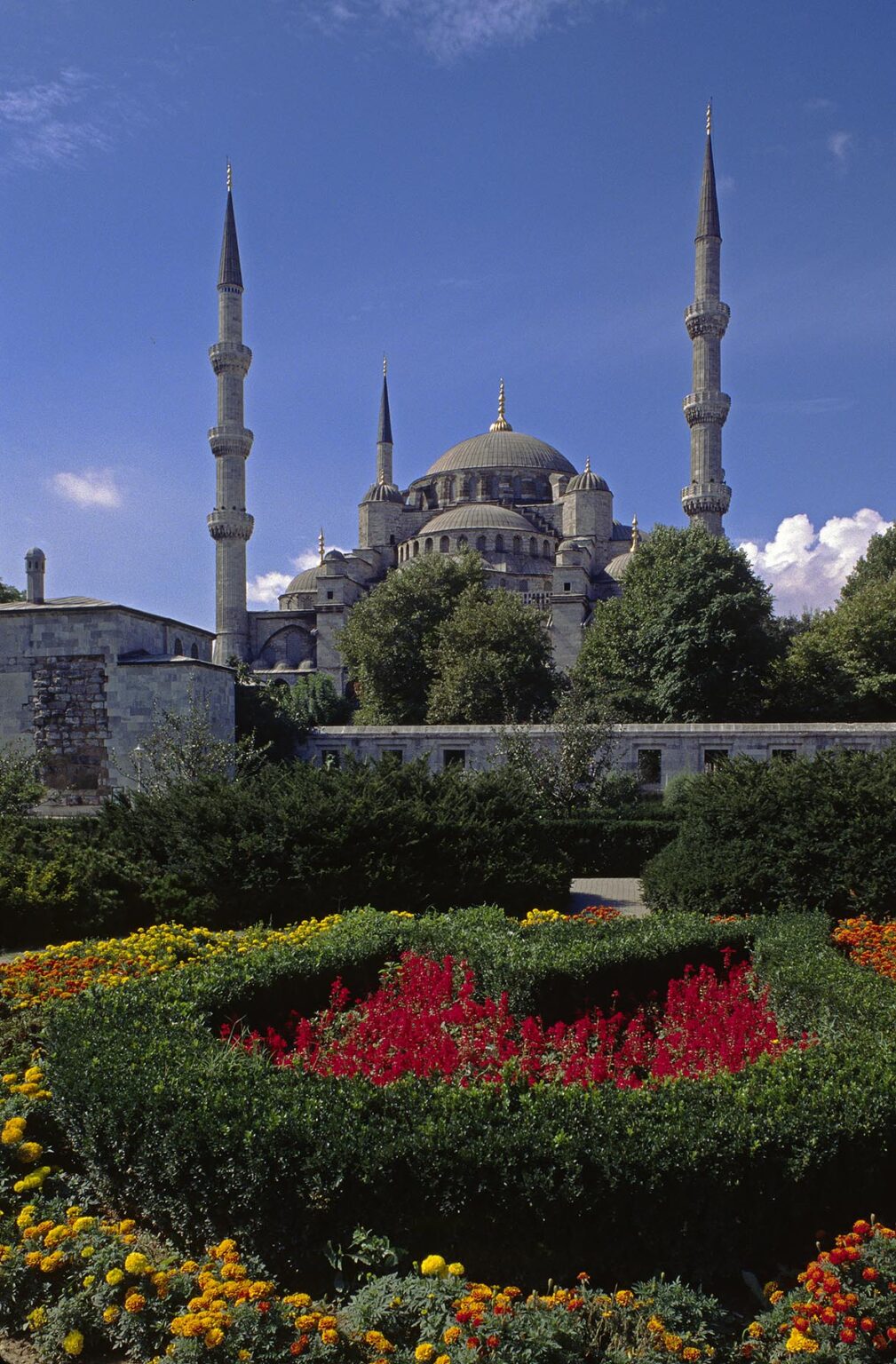 Flower gardens and The Blue Mosque (Sultanahmet Camii) which was completed in 1616 and has 6 Minarets and 260 windows - Istanbul, Turkey