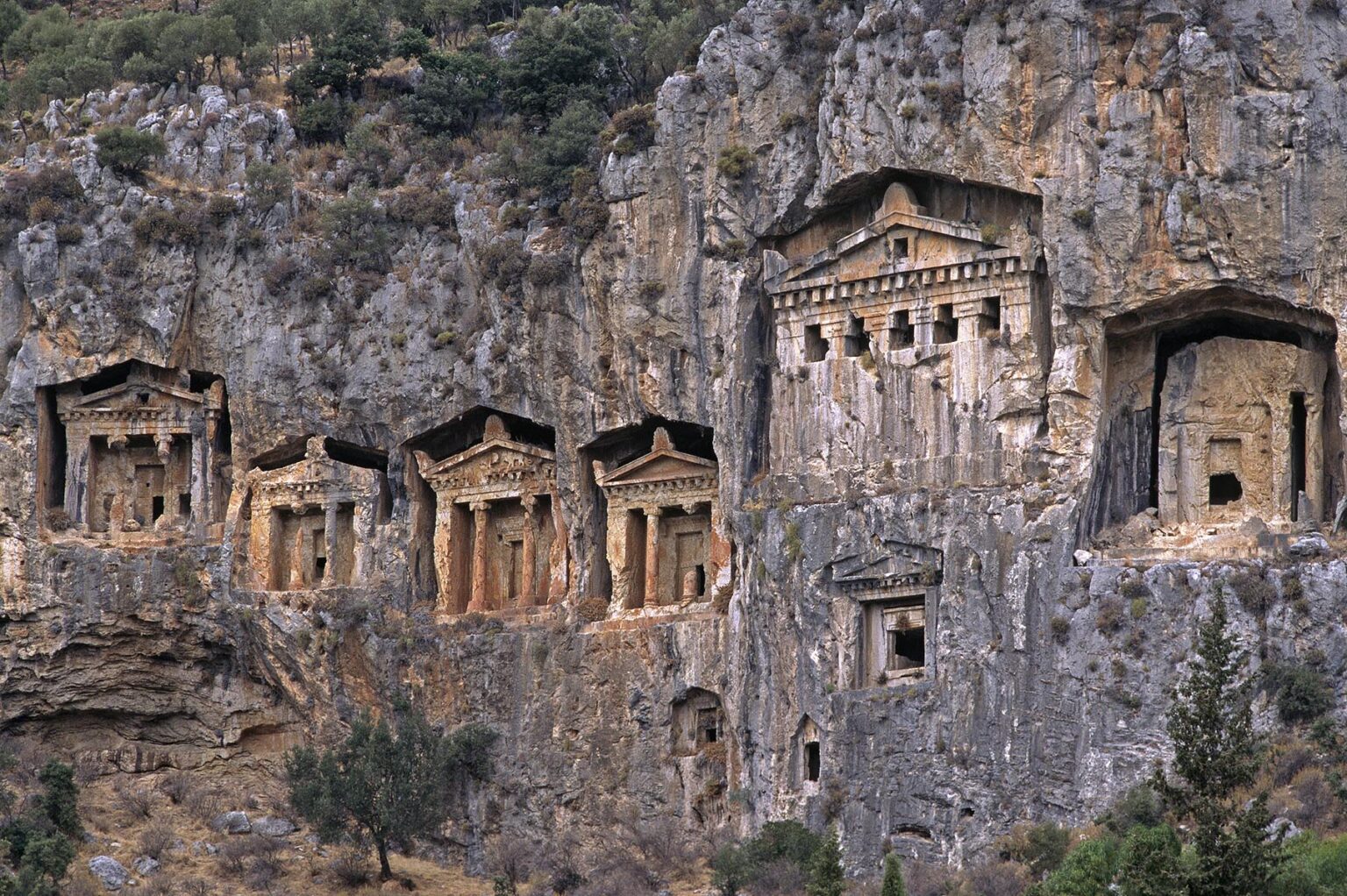 The ancient tombs carved into cliffs near The Ruins of CAUNUS (400 BC onwards) - TURQUOISE COAST, TURKEY