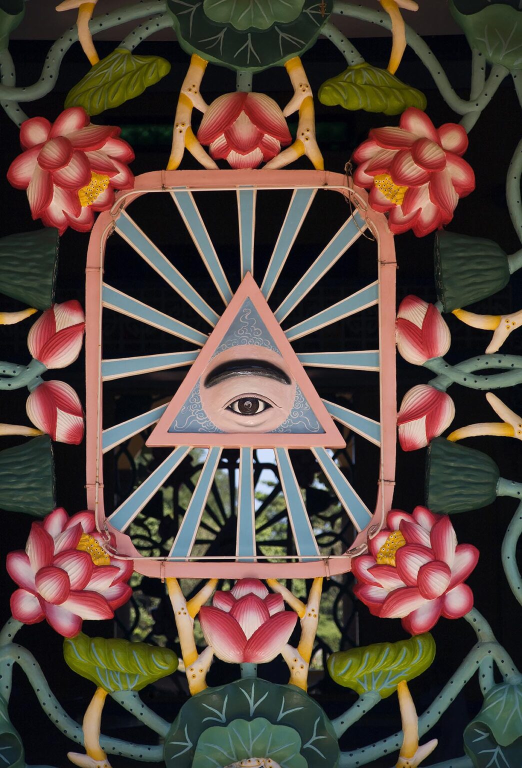 A window display depicting the DIVINE EYE at the CAO DAI GREAT TEMPLE, TAY NINH VILLAGE, VIETNAM