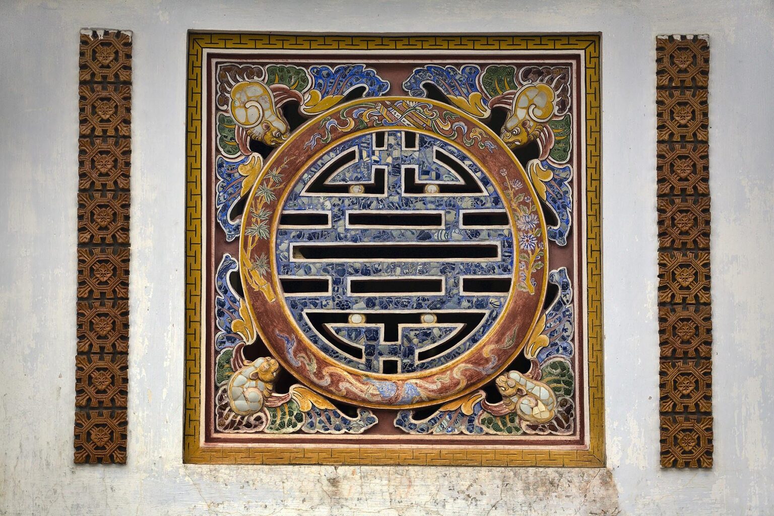 Detail of a tile sculpture on the wall of the HALL OF THE MANDARINS,  IMPERIAL CITADEL - HUE, VIETNAM