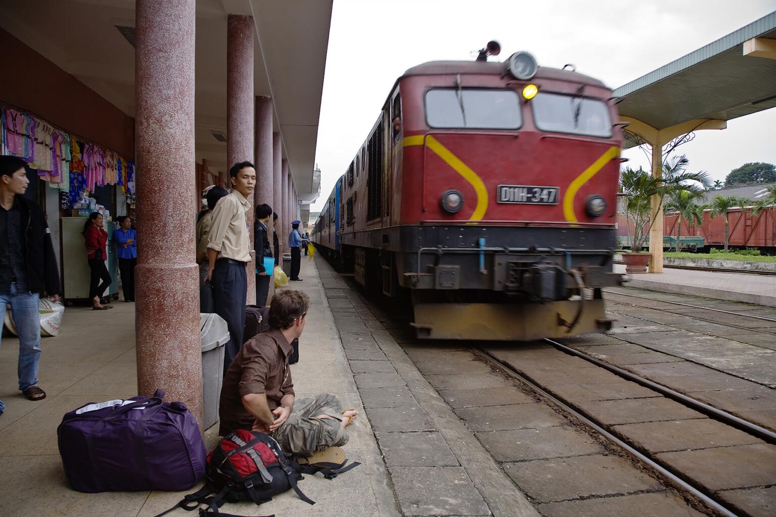 A tourist waiting for an arriving train - HUE, VIETNAM