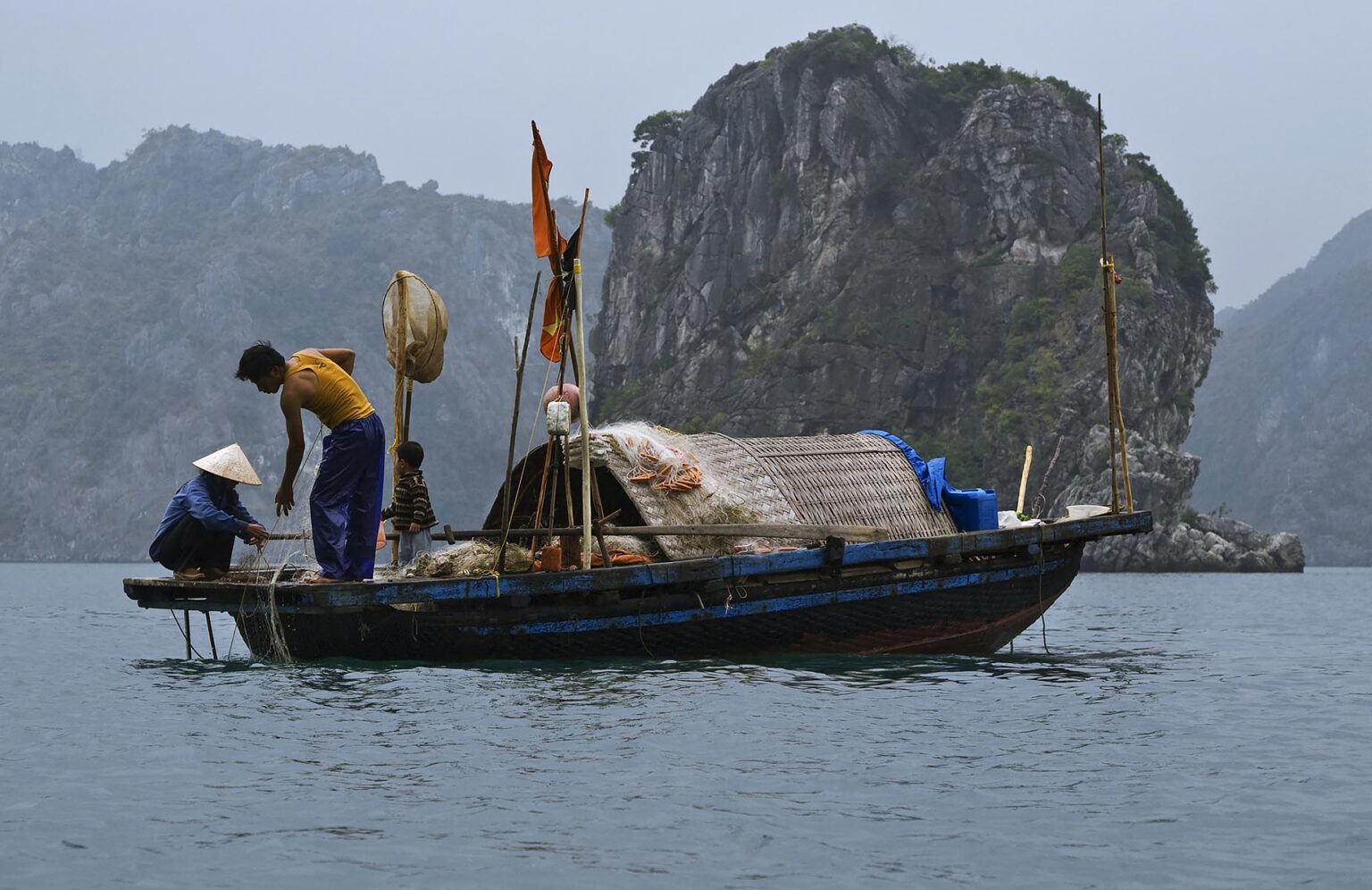 FISHERMEN at work in the waters of HALONG BAY - VIETNAM