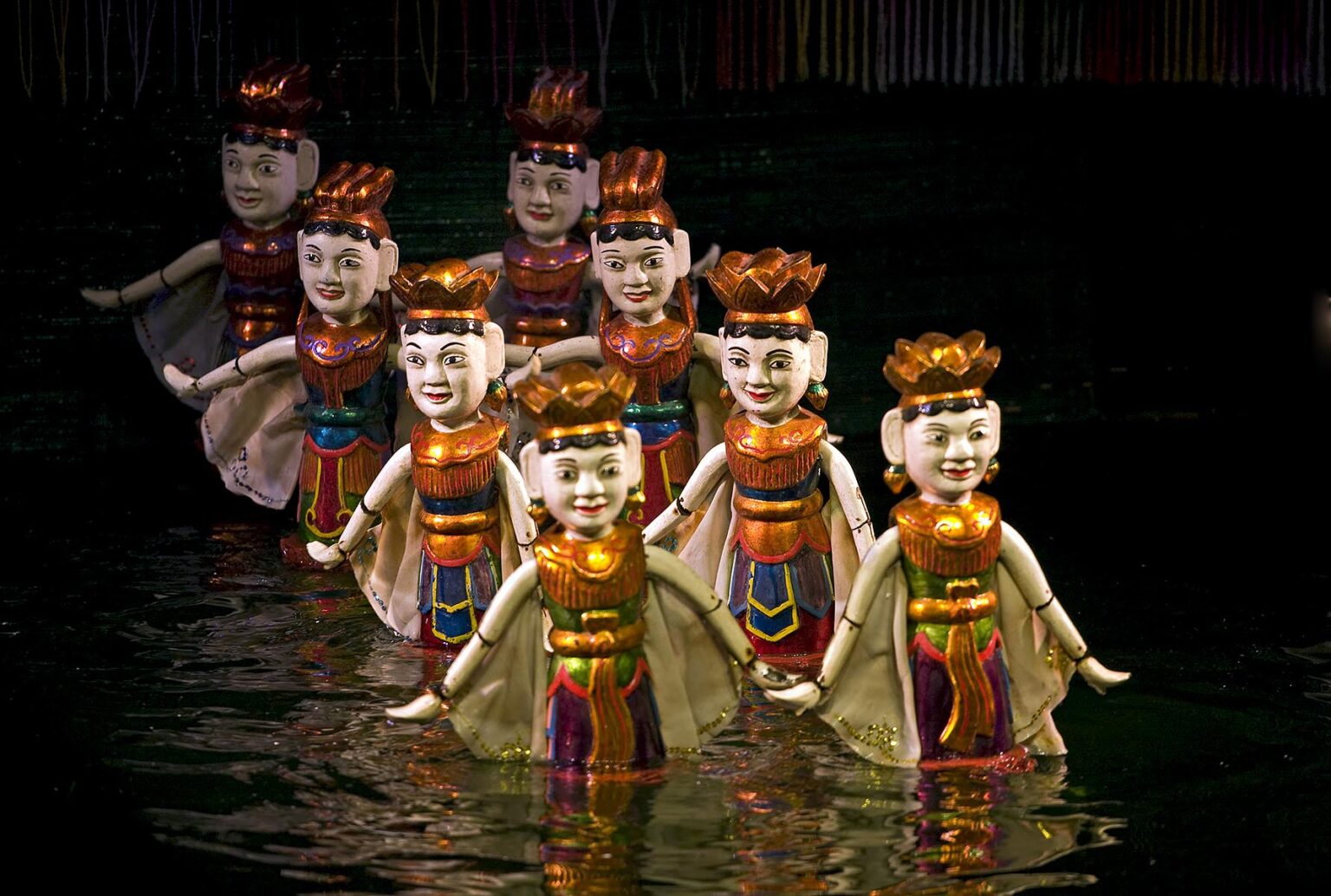 Dancing women during the performance at the THANG LONG WATER PUPPET THEATRE - HANOI, VIETNAM