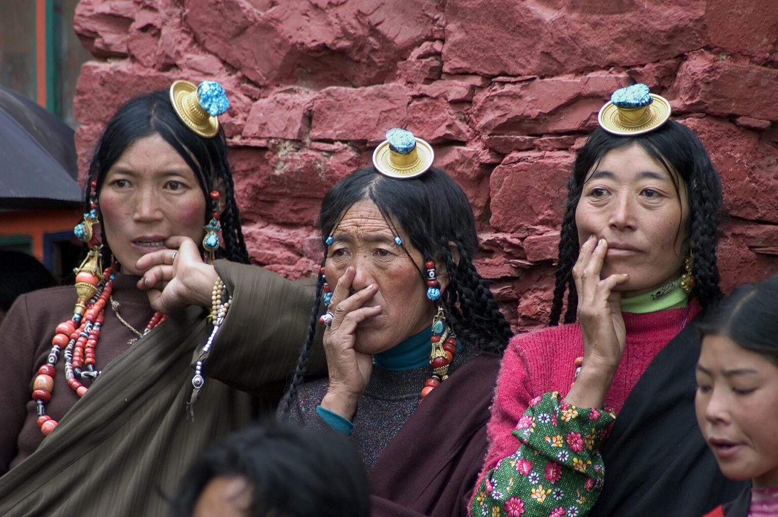 Three Khampa women watch the  Cham Dances, Katok Dorjeden Monastery - Kham, (eastern, Tibet), Sichuan Province, China
