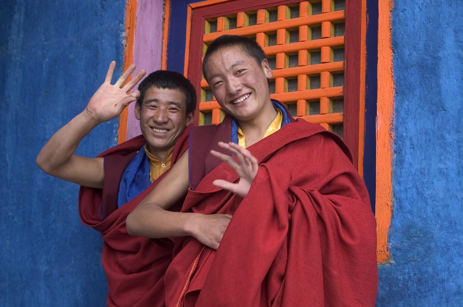 Tibetan Buddhist Monks wave at the Cham dances at the Katok Dorjeden Monastery - Kham, (eastern, Tibet), Sichuan, China
