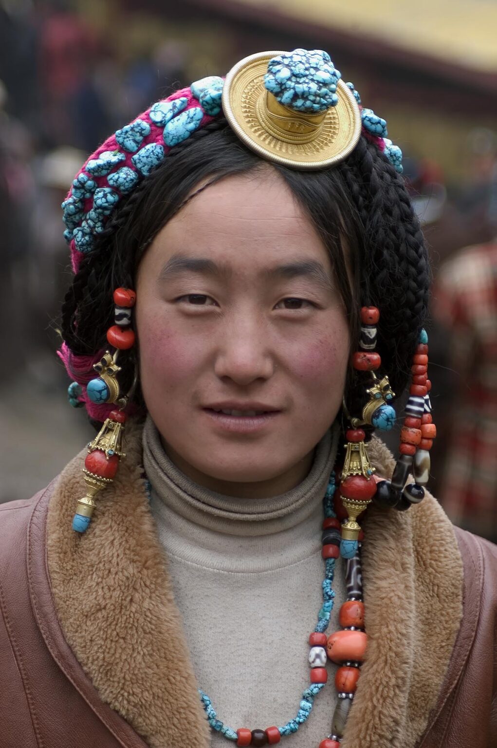 Khampa woman wears a gold and turquoise hair piece at the Monlam Chenpo, Katok Monastery - Kham, (Tibet), Sichuan, China