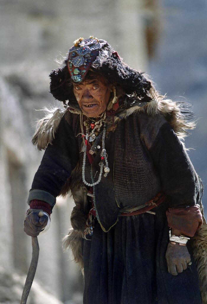 OLD LADAKHI WOMAN wearing traditional sheepskin, chuba, and PERAK (bejeweled head piece), LAMAYURU - LADAKH, INDIA