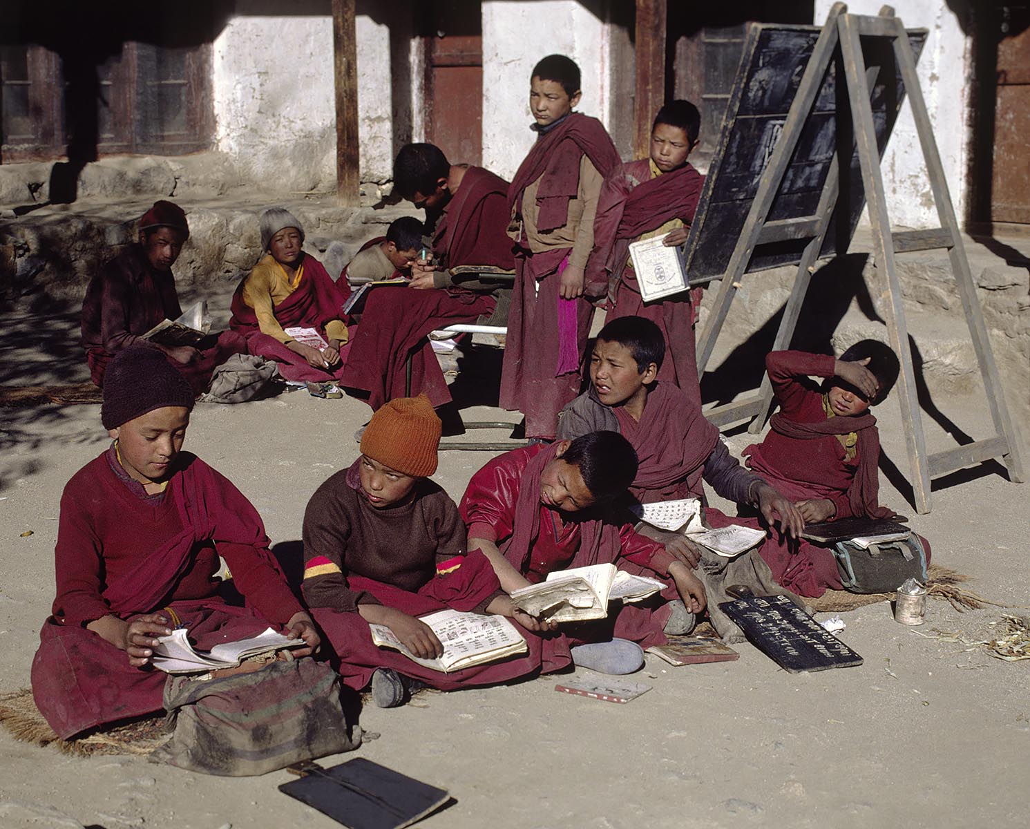 Young BUDDHIST MONKS study during class in the monastic SCHOOL at LEKIR GOMPA (monastery) - LADAKH, INDIA