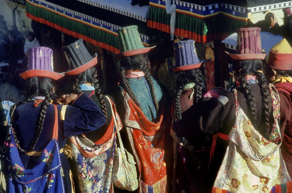 Ladakhi women wearing traditional SILK EMBROIDERED TALL HATS, TIKSE Monastery Masked Dances - LADAKH, INDIA