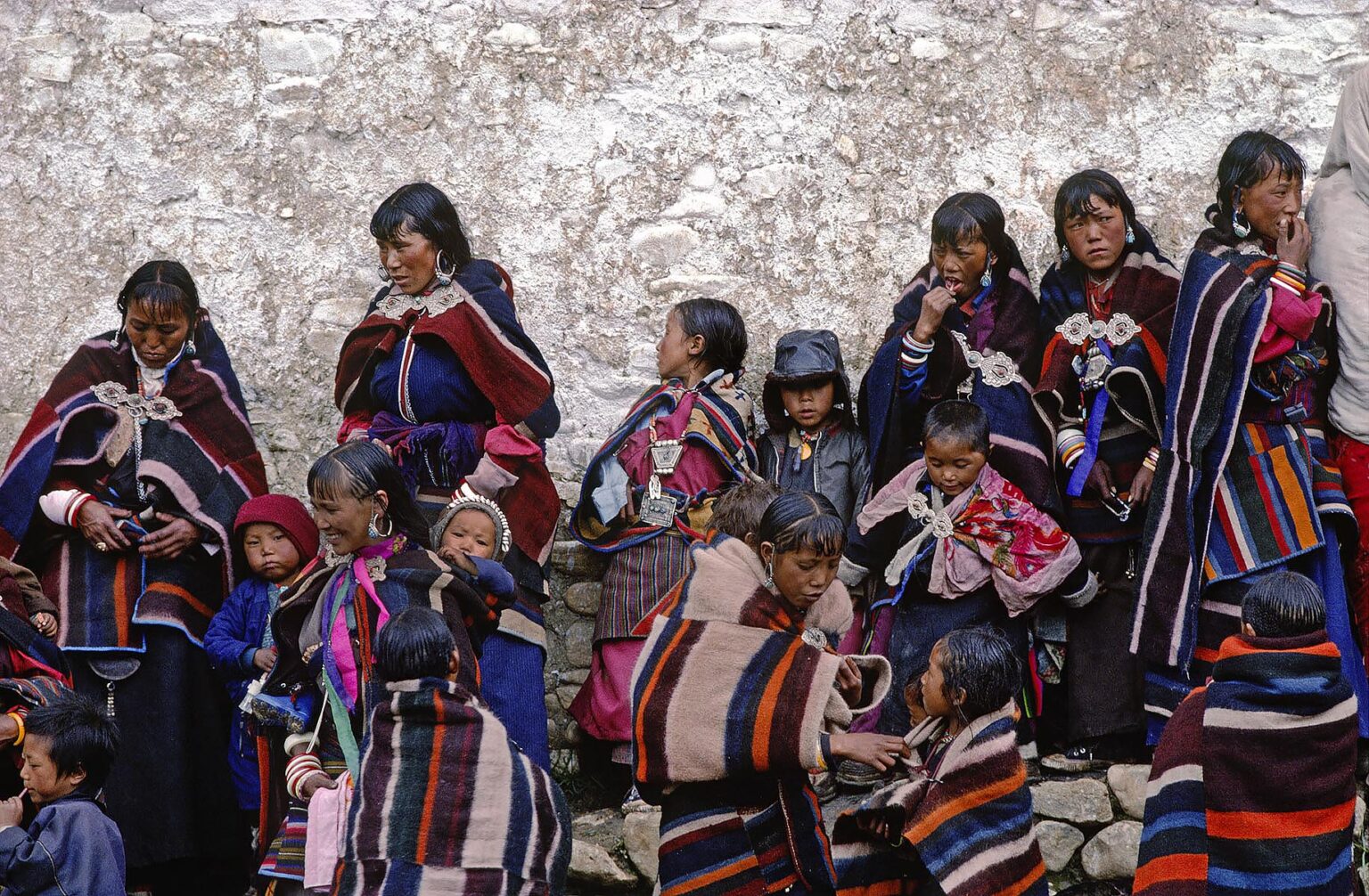 WOMEN and children in DOLPO BLANKETS gather at a Tibetan Buddhist FESTIVAL in the DO TARAP VALLEY - DOLPO DISTRICT, NEPAL