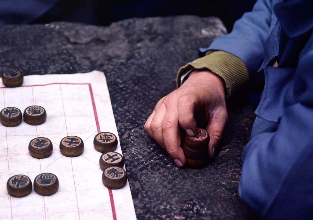 A Chinese MAN CONCENTRATES as he plays a game of CHINESE CHECKERS in KUNMING - YUNNAN, CHINA