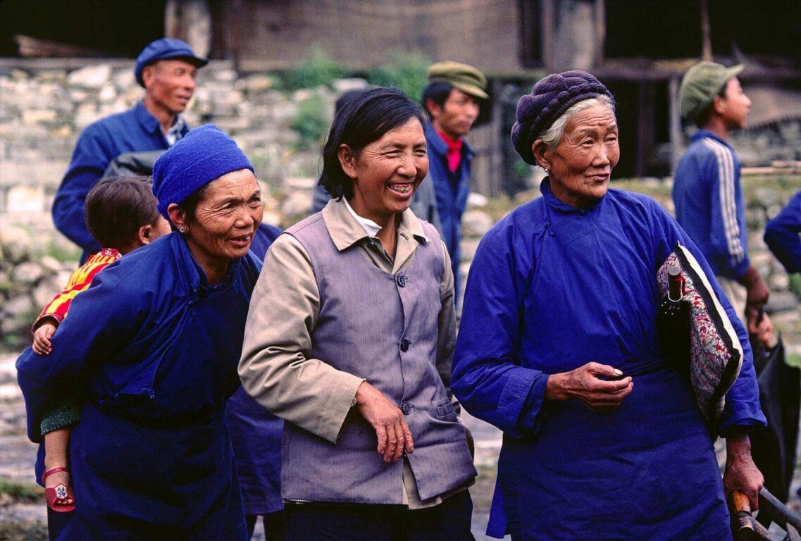 WOMEN of the minority BAI ethnic group SMILE and walk together in the Chinese farming town of DALI - YUNNAN, CHINA