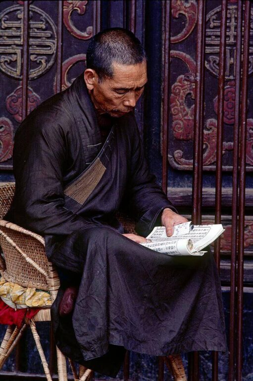 A Buddhist monk reads the scriptures in a temple in Kunming China