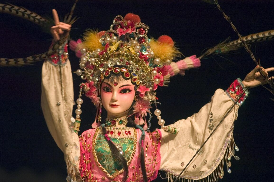Female Puppet with beautiful feather headdress in a traditional Chinese Puppet Show - Chengdu, China in Sichuan Province