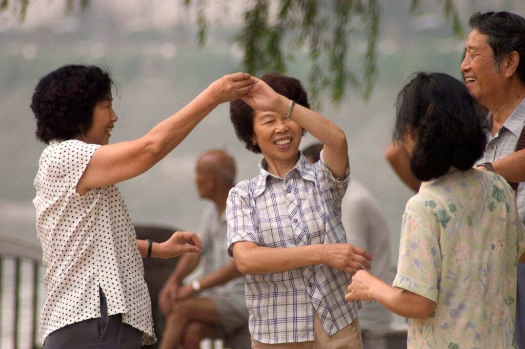 Chinese women practice ballroom dancing in a park along the Jin River - Chengdu, China in Sichuan Province
