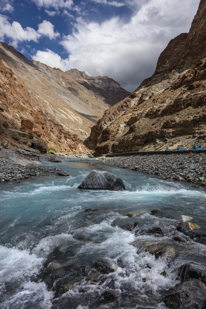 The clear waters of the MARKHA RIVER feeds into the ZANSKAR RIVER - ZANSKAR, LADAKH, INDIA