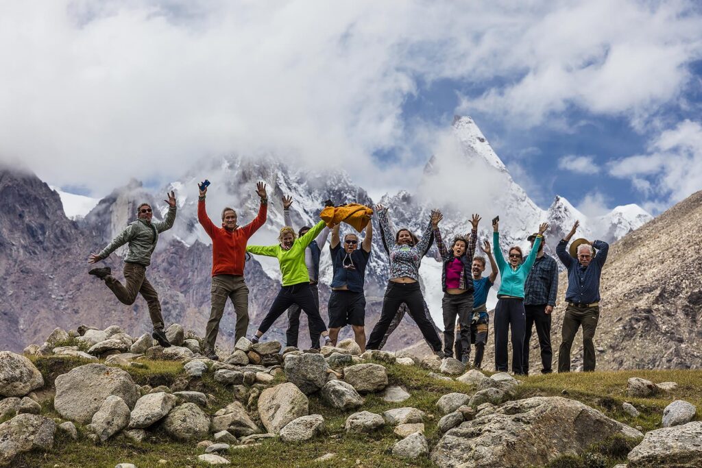 Travelers infront of the massive himalayan peaks of NUN and KUN which reach a height of23,409 feet - ZANSKAR, LADAKH, INDIA