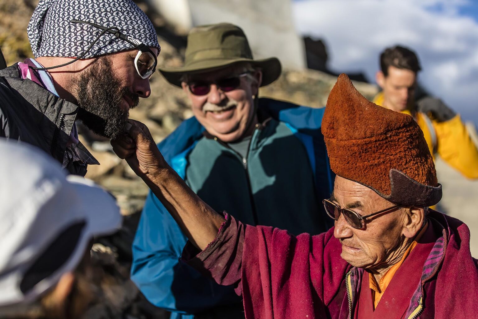 Visitors interact with a BUDDHIST MONK at KARSHA GOMPA the largest Buddhist Monastery in the STOD RIVER VALLEY - ZANSKAR, LADAKH, INDIA