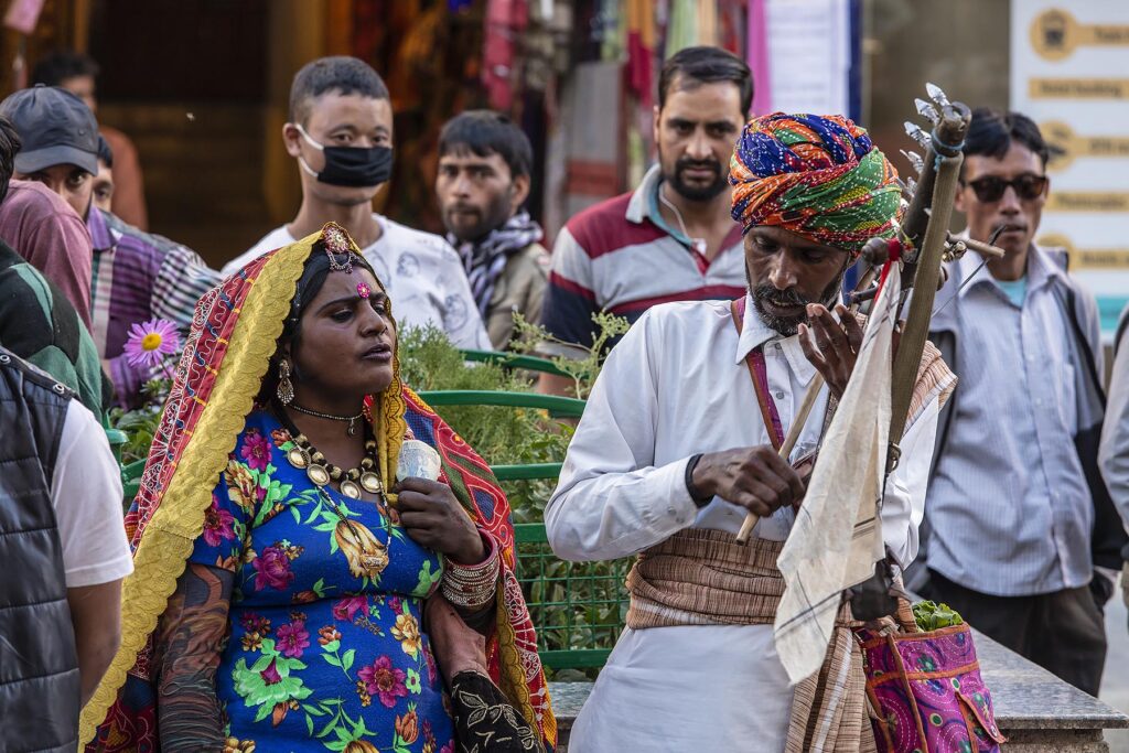 An Indian couple preform with a traditinal stringed instruent and singing - LEH, LADAKH, INDIA