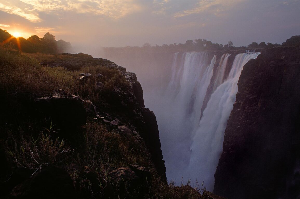 VICTORIA FALLS on the ZAMBEZI RIVER is AFRICA'S most spectacular waterfall & divides ZAMBIA and ZIMBABWE