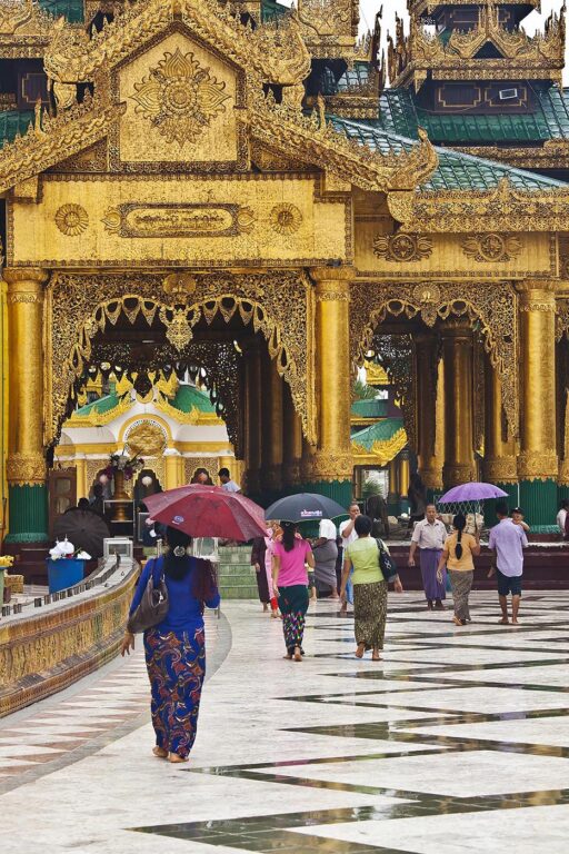 BURMESE with umbrellas at the SHWEDAGON PAYA or PAGODA which dates from 1485 - YANGON, MYANAMAR