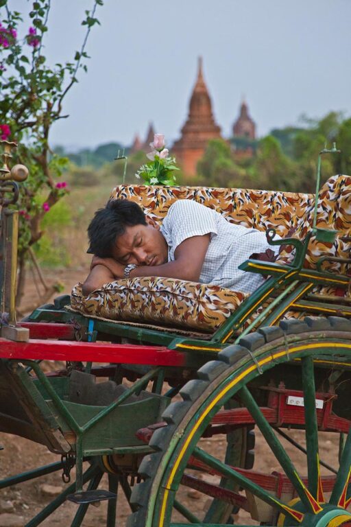 A cart driver takes a rest during a dawn mission - BAGAN, MYANMAR